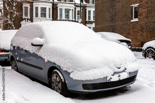 Street winter cityscape with snow covered frozen cars after a blizzard snowfall in London England UK, stock photo image © Tony Baggett