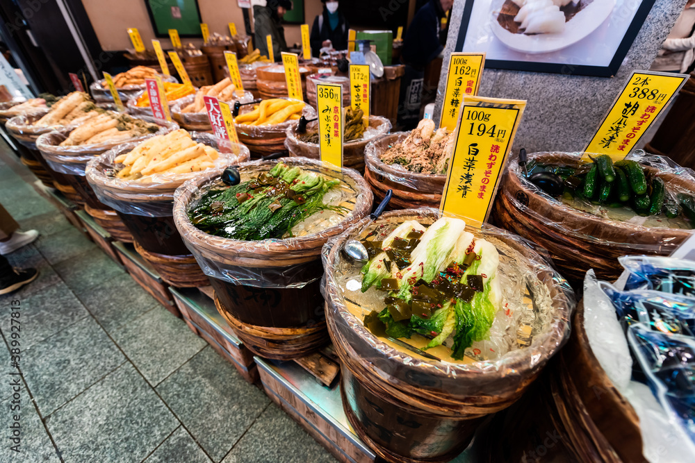 Fototapeta premium Kyoto, Japan - April 17, 2019: Containers of pickles pickled vegetables on sale display in Nishiki market street