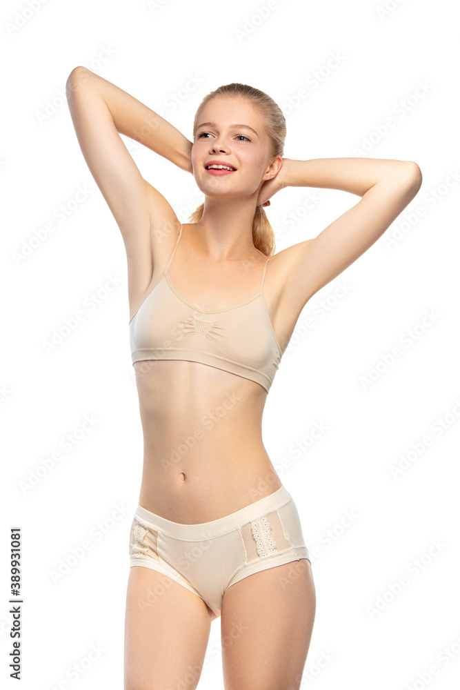 Healthful. Beautiful female model on white background. Beauty, cosmetics, spa, depilation, diet and treatment, fitness concept. Fit and sportive, sensual body with well-kept skin in underwear. Healthful. Beautiful female model on white background. Beauty, cosmetics, spa, depilation, diet and treatment, fitness concept. Fit and sportive, sensual body with well-kept skin in underwear.