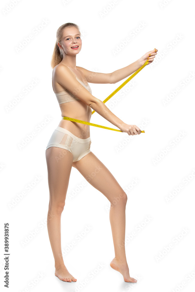 Perfect figure. Beautiful female model on white background. Beauty, cosmetics, spa, depilation, diet and treatment, fitness concept. Fit and sportive, sensual body with well-kept skin in underwear. Perfect figure. Beautiful female model on white background. Beauty, cosmetics, spa, depilation, diet and treatment, fitness concept. Fit and sportive, sensual body with well-kept skin in underwear.
