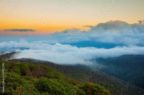 Fog sits over the valley in the Blue Ridge Mountains of North Carolina at sunset.