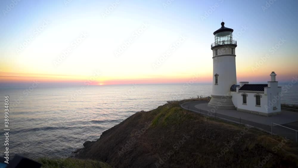 Lighthouse Tower on Top of Hill and Sunset Above Pacific Ocean on Skyline, Cape Disappointment, American Coastline and 19th Century Landmark, Panorama Lighthouse Tower on Top of Hill and Sunset Above Pacific Ocean on Skyline, Cape Disappointment, American Coastline and 19th Century Landmark, Panorama