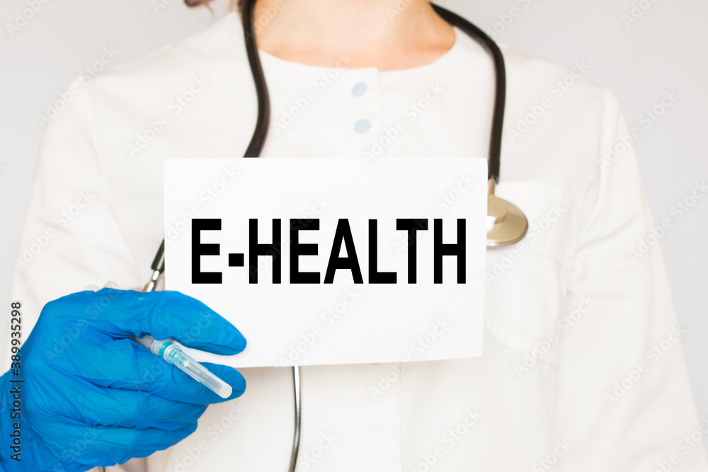 The doctor's blue - gloved hands show the word E-HEALTH - . a gloved hand on a white background. Medical concept. the medicine The doctor's blue - gloved hands show the word E-HEALTH - . a gloved hand on a white background. Medical concept. the medicine