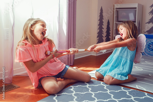 Canvas Print Two little mad angry girls sisters having fight at home
