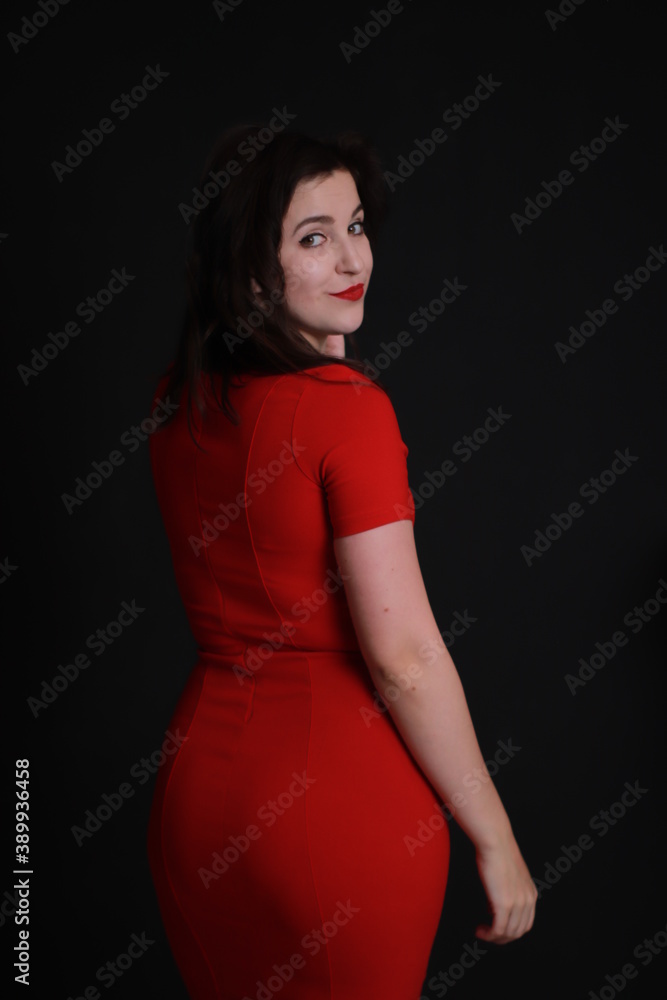sexy attractive brunette in red skinny dress isolated on black background. studio shoot. emotional actress. . sexy attractive brunette in red skinny dress isolated on black background. studio shoot. emotional actress. .