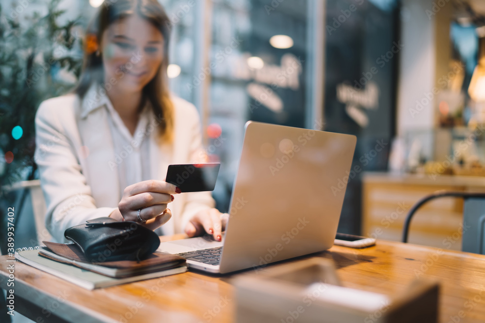 Blurred female checking cvv code on plastic credit card for making banking payment while installing application for projecting via laptop computer, skilled freelancer using debit with cvv code Blurred female checking cvv code on plastic credit card for making banking payment while installing application for projecting via laptop computer, skilled freelancer using debit with cvv code
