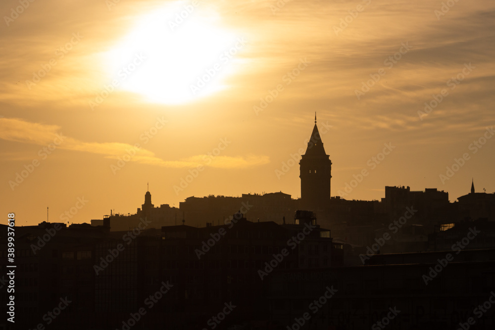 Galata Tower at sunset. Sun over the Galata Tower. Cityscape of Istanbul with Galata Tower at sunset. 