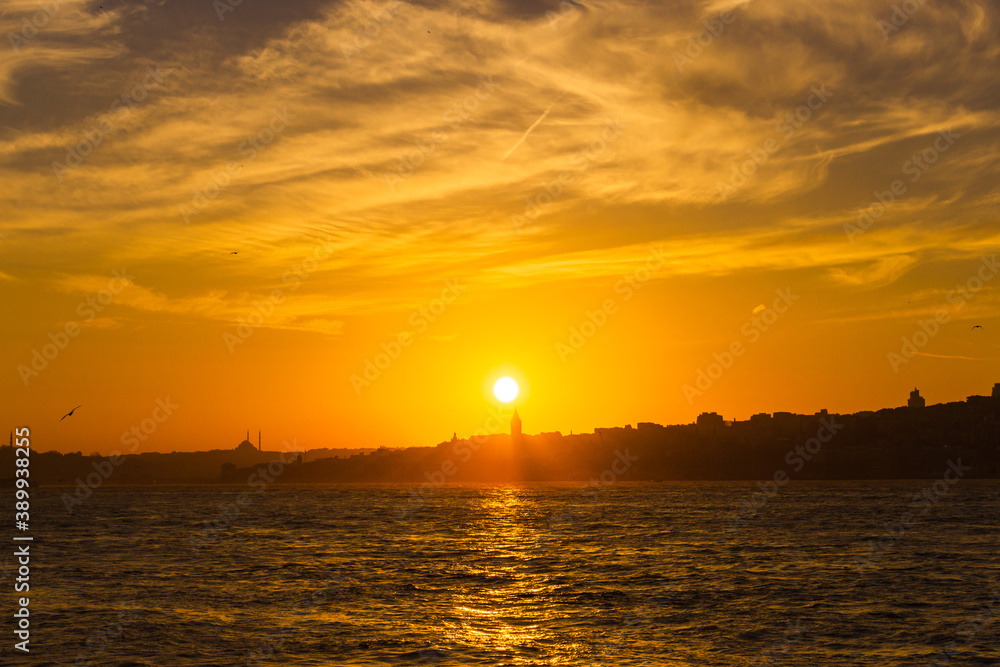 Galata Tower at sunset. Sun over the Galata Tower. Cityscape of Istanbul with Galata Tower at sunset. 