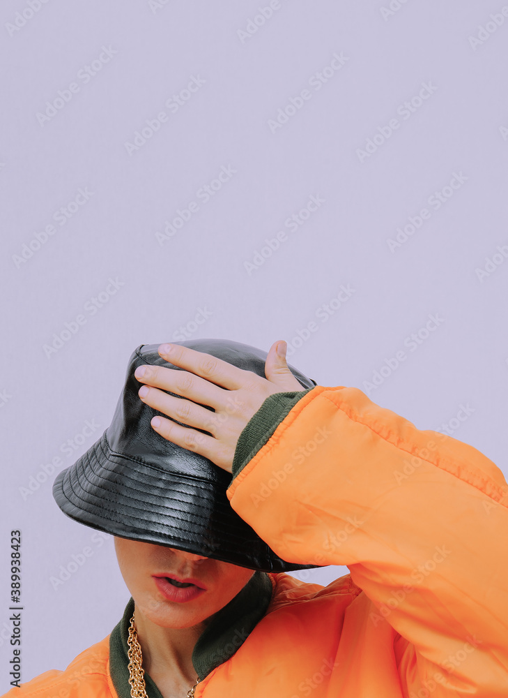Girl in urban street outfit. Trendy orange bomber jacket and stylish black hat. Fall winter seasons lookbook. Hipster Style in details Stock Photo | Adobe Stock