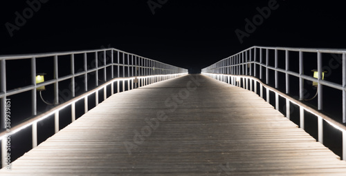 wooden illuminated resort bridge at night