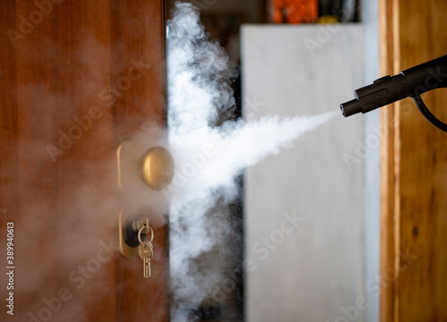 Fotografie disinfection and sanitization with steam at home, steam flow is directed to the