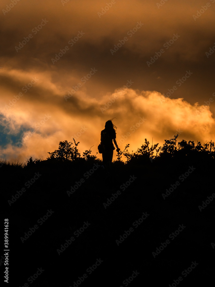 Woman shadow in a orange sunset