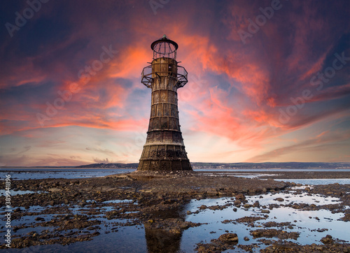 This derelict iron lighthouse is situated on Whiteford Sands, the Gower, Swansea. It is the last iron lighthouse in Europe. Sun setting at the end of a winter day.
