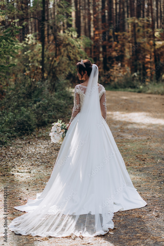 The bride holds a bouquet of roses. Portrait of the bride. Beautiful wedding bouquet. 