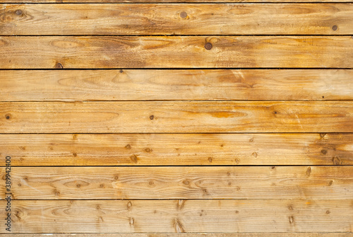 Texture of wooden board. Yellow lacquered table top. Old shabby lacquered board.