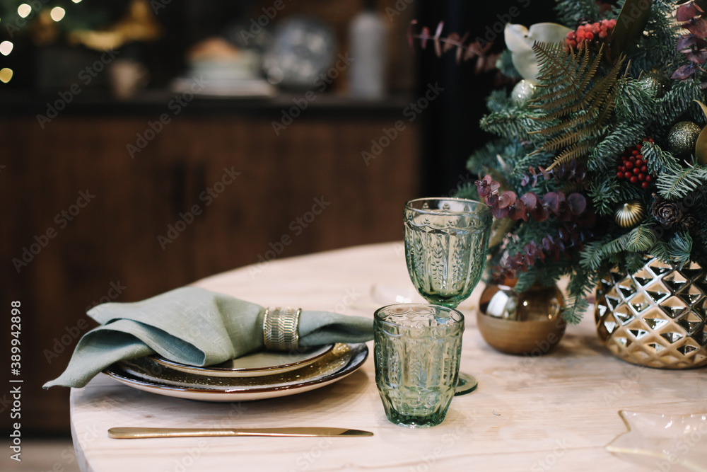 Festive table setting for Christmas dinner. New Year holidays celebration decorations in modern interior design. Festive table setting for Christmas dinner. New Year holidays celebration decorations in modern interior design.