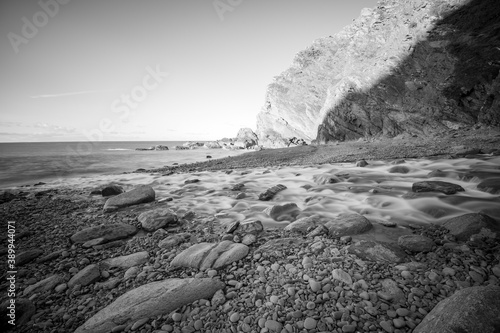 Long exposure of the river Heddon flowing onto the beach at Heddons Mouth in Exmoor photo