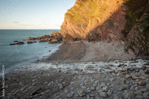 Long exposure of the river Heddon flowing onto the beach at Heddons Mouth in Exmoor photo