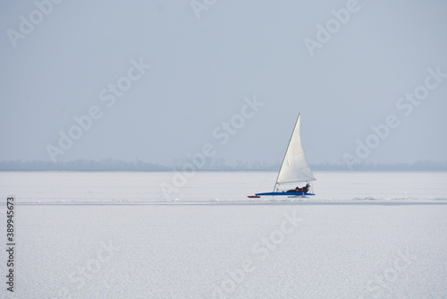 full speed ice sailor on frozen lake in action