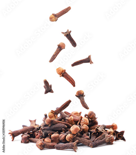 Dry cloves seasoning whole drops on a heap on a white background. Isolated