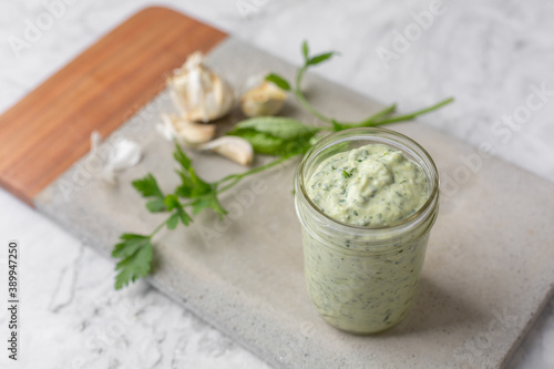Wallpaper Mural Homemade Green Goddess Dressing in a Jar on a Cement Cutting Board on White Marb