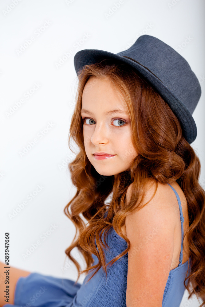 dressed in a light blue dress on spaghetti straps cute little girl on a white background dressed in a light blue dress on spaghetti straps cute little girl on a white background
