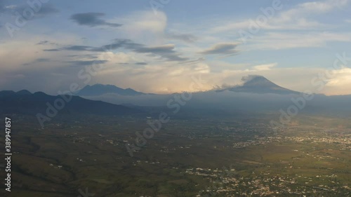 Aerial drone 4k footage of Popocatepetl and Iztaccihuatl volcanoes from Oaxtepec, Morelos, Mexico at sunset photo