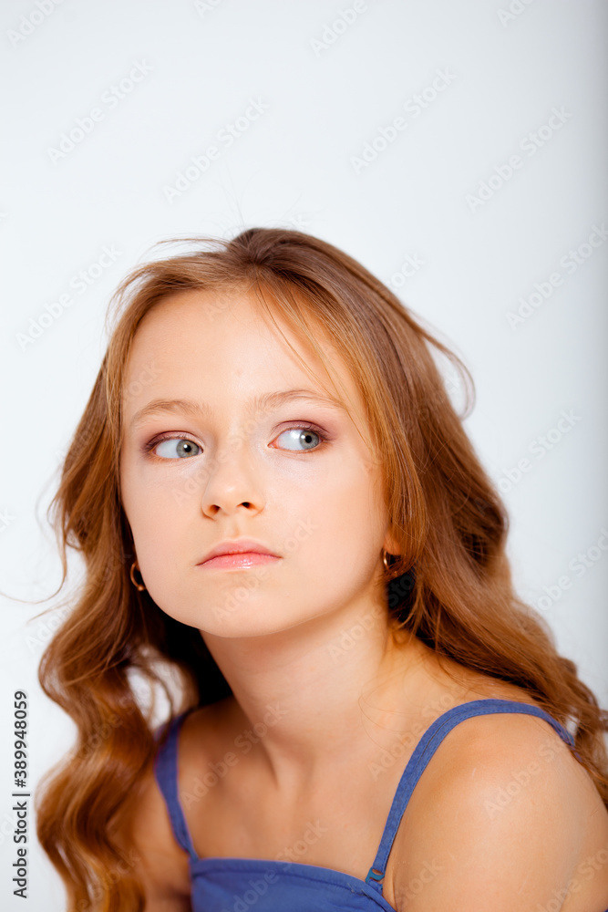 dressed in a light blue dress on spaghetti straps cute little girl on a white background dressed in a light blue dress on spaghetti straps cute little girl on a white background