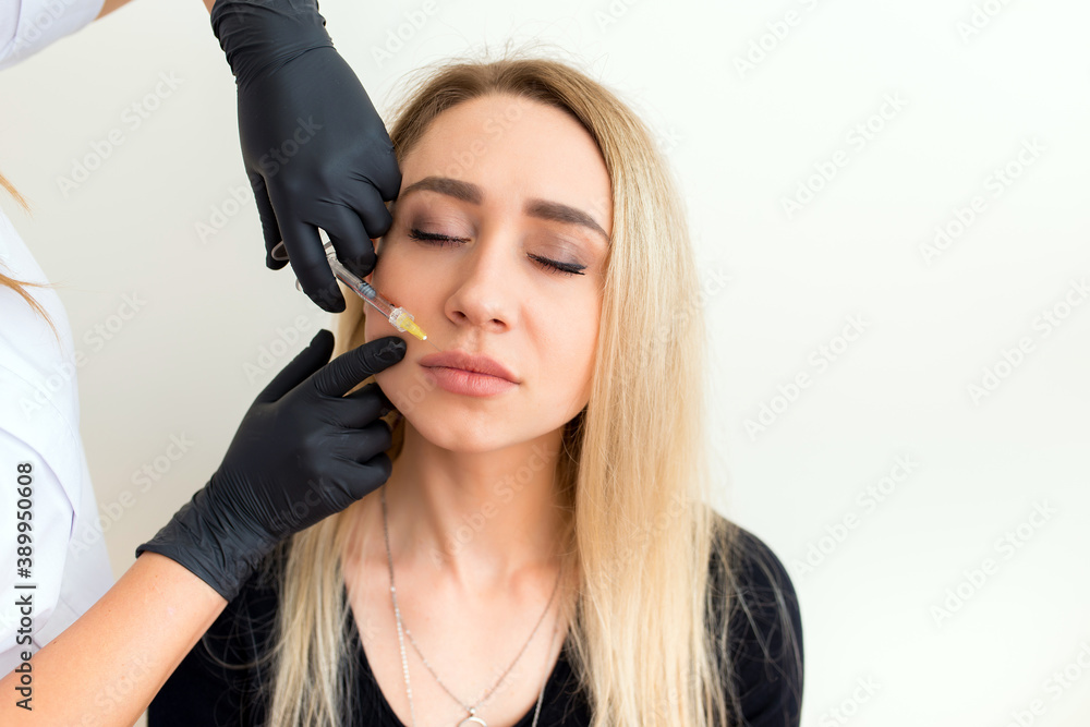 beautician makes an injection to a woman beautician makes an injection to a woman