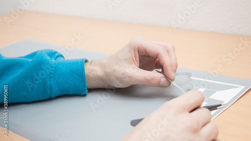 Print job, hands cutting plotter in printing house