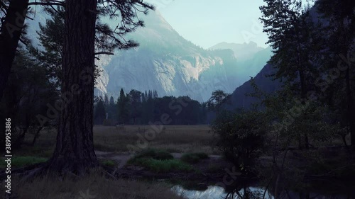 Early morning light rakes across a granite wall in the Yosemite Valley, Yosemite National Park, California. photo