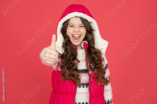 Winter warmness. happy teen girl wear warm clothes. winter kid fashion. child with long curly hair in christmas aparrel. cold season activity style. childhood happiness. thermal clothing photo