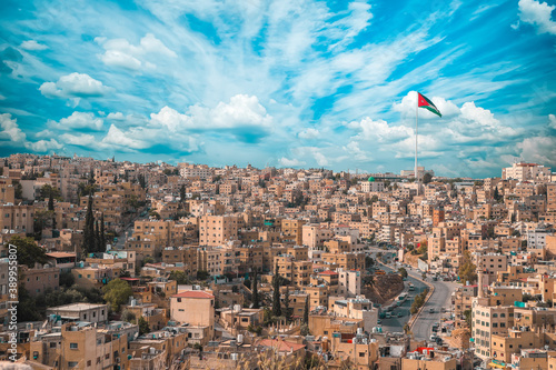 Slika na platnu Scenic shot of the city of Amman with the Jordan flag in Jordan