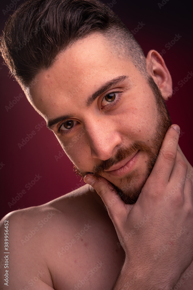 Young muscle man with red background Young muscle man with red background