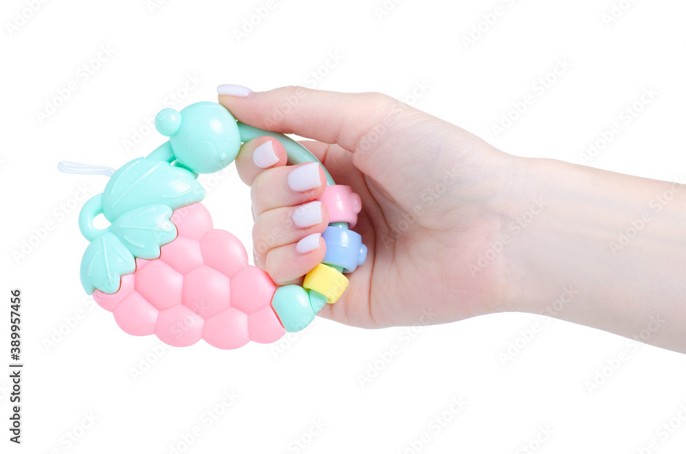 Baby rattle toy in hand on white background isolation Baby rattle toy in hand on white background isolation