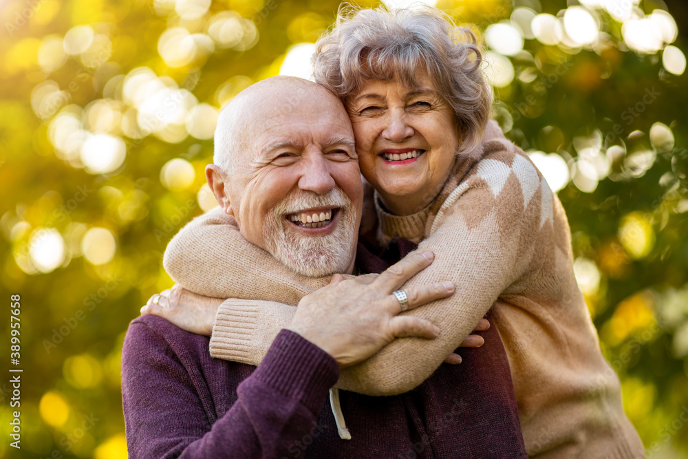Happy senior couple spending time together in beautiful city park in autumn Happy senior couple spending time together in beautiful city park in autumn