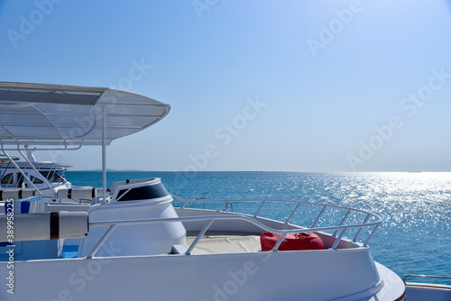 White yacht at sea against blue sky