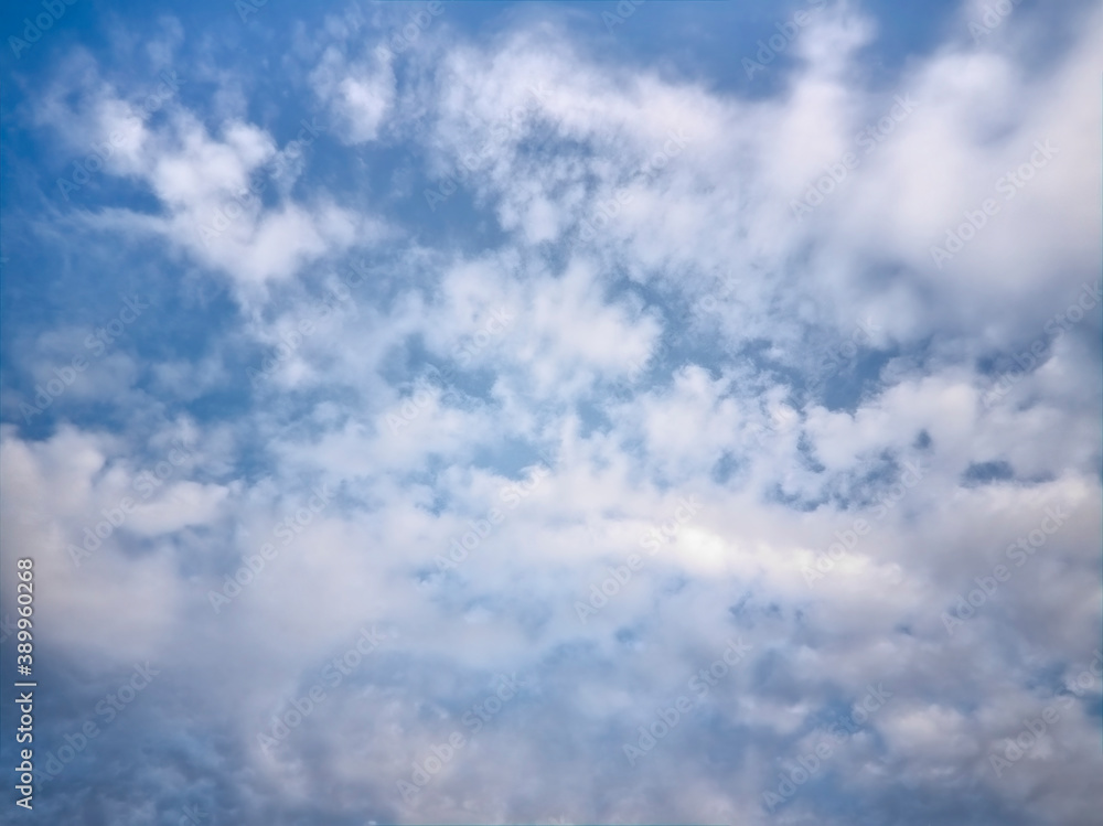 Blue summer sky with white cumulus clouds. Blue sky with clouds nature background. Blue summer sky with white cumulus clouds. Blue sky with clouds nature background.