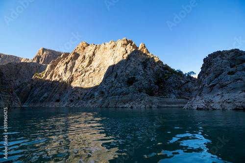 Boat tour on the river in the canyon. Cliffs of the canyon from the level of river ground. canyon at sunset.