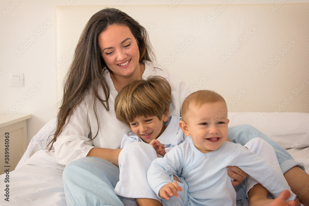 Mom And Children Playing.
A Mother And Her Children Play In Bed. Family Lifestyle.