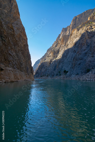 Boat tour on the river in the canyon. Cliffs of the canyon from the level of river ground. canyon at sunset.
