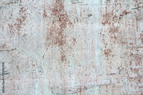 Retro concrete weathered wall old texture with rust leaks, with white, brown, gray and beige spots.. Design template. An old crumbling plaster. The background for text and design. © Stanislav