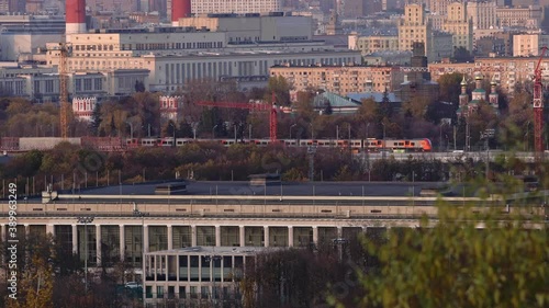modern electric passenger train moving in the center of Moscow in late autumn