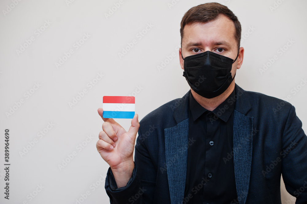 European man wear black formal and protect face mask, hold Luxembourg