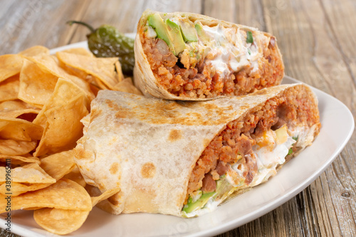 A view of a burrito plate, in a restaurant or kitchen setting.