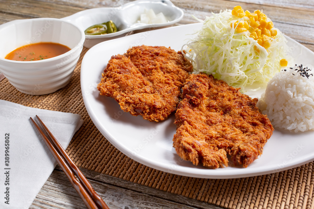 A view of a plate of chicken tenderloin katsu. A view of a plate of chicken tenderloin katsu.