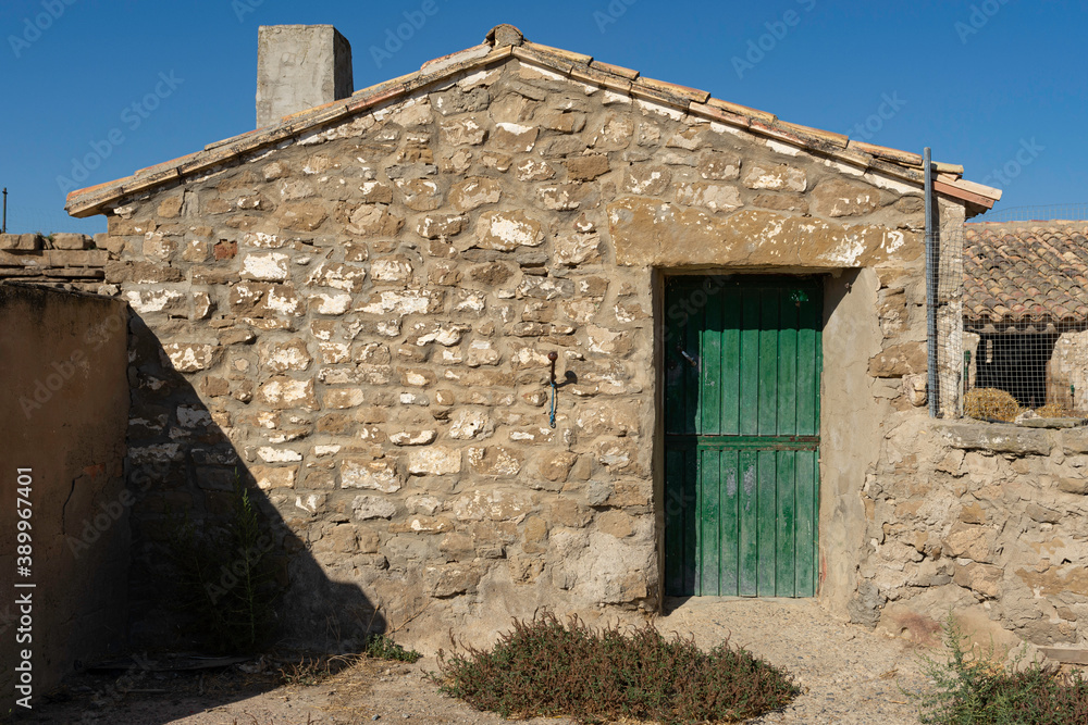 old stone farmhouse with a green wooden door