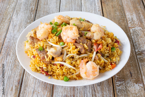 A view of a plate of meat fried rice, featuring shrimp, pork, and beef.