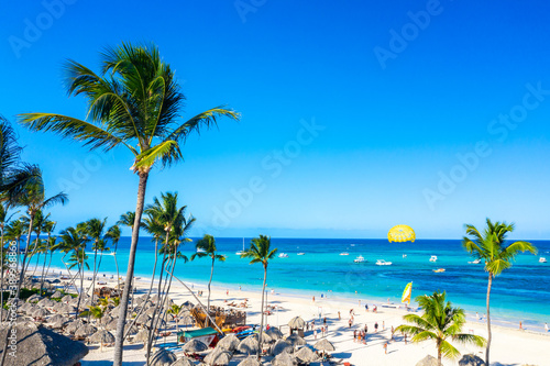 Fototapeta Naklejka Na Ścianę i Meble -  Aerial view of Bavaro beach Punta Cana tropical resort in Dominican Republic. Beautiful atlantic tropical beach with palms, umbrellas and parasailing balloon