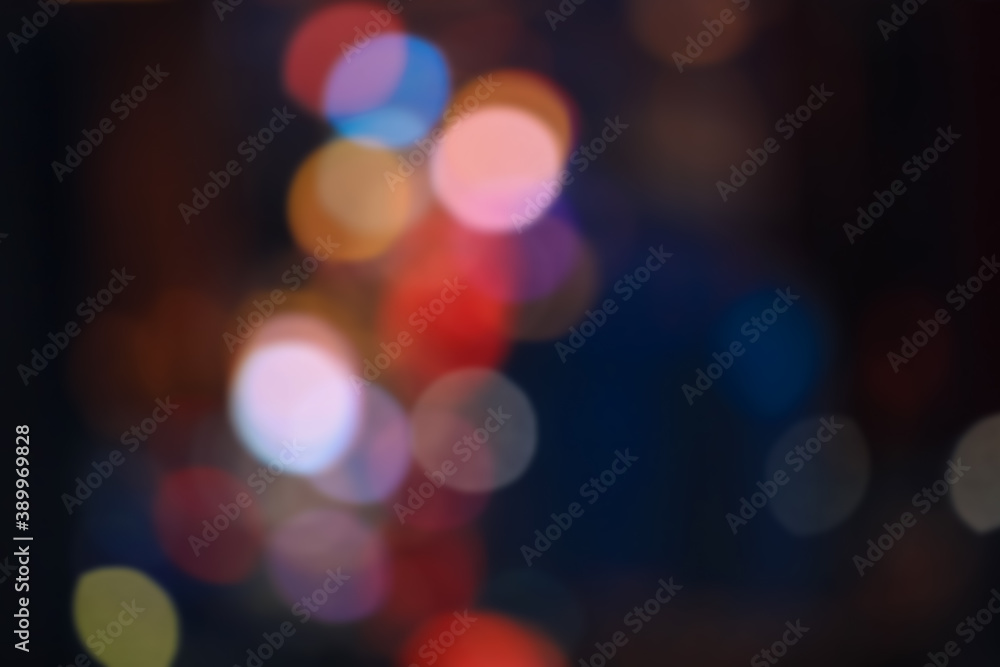 Colorful city lights intentionally kept out of focus for abstract background use.